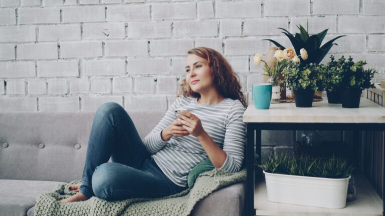 Woman in her 30s relaxing on a sofa
