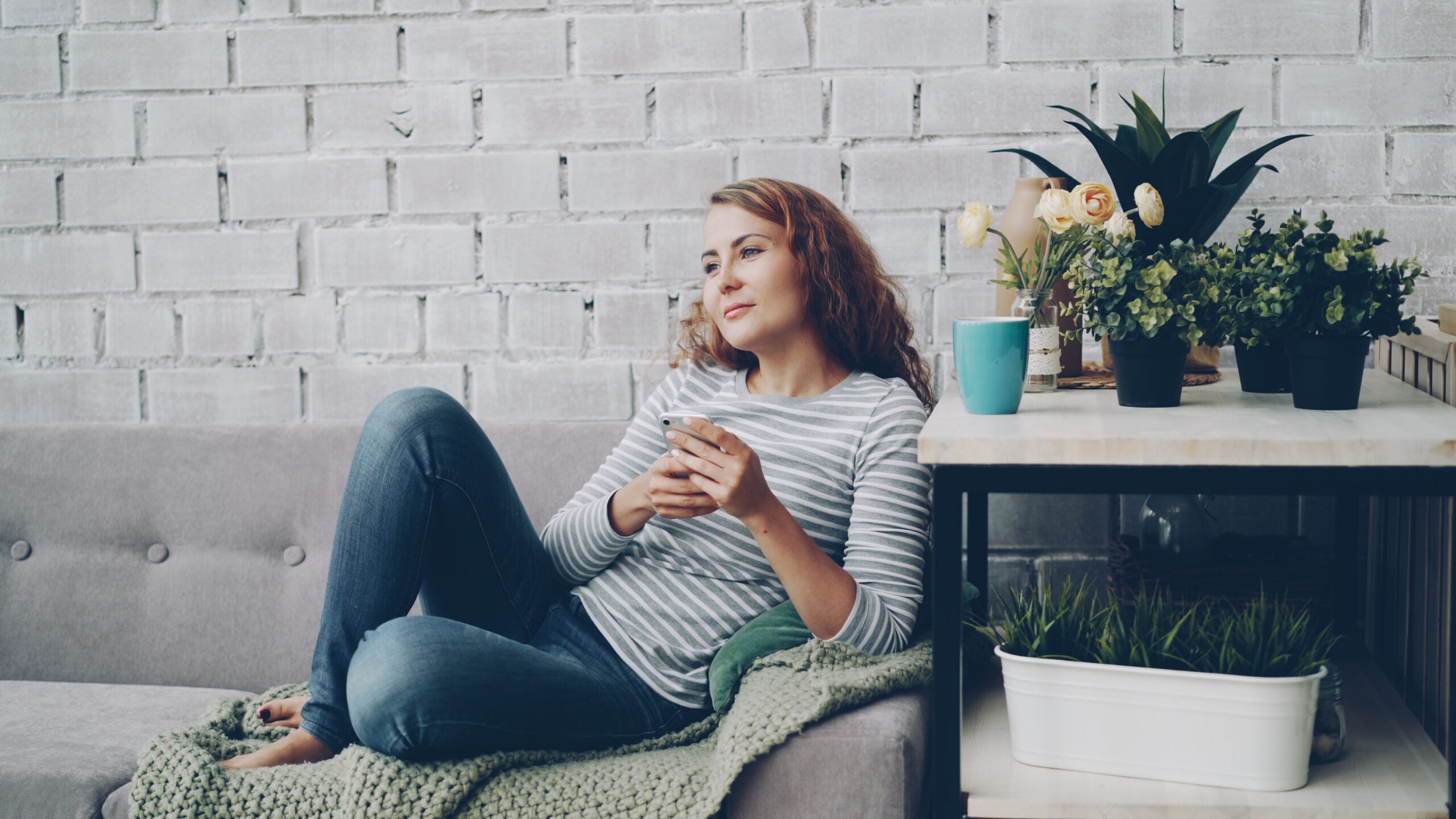 Woman in her 30s relaxing on a sofa